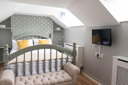 a bedroom with a bed and a tv in a room at The Old Bakery in Lincoln
