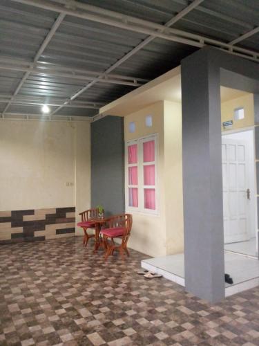 a room with a table and chairs in it at Soraya Homestay 2 in Tulungagung