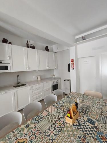 a kitchen with a table with a box of toys on it at FlorAL in Aljezur
