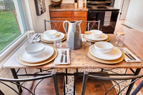 a wooden table with plates and dishes on it at Louisville Louvre in Louisville