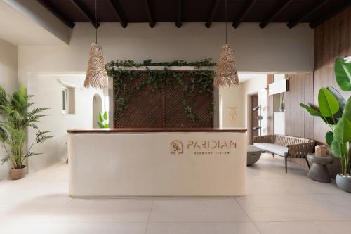 a reception desk in a room with plants at Paridian Elegant Living in Parikia