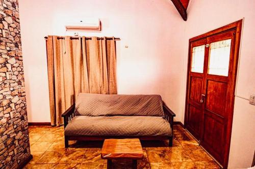 a room with a bed and a door and a table at Cabaña Amare in Puerto Bossetti