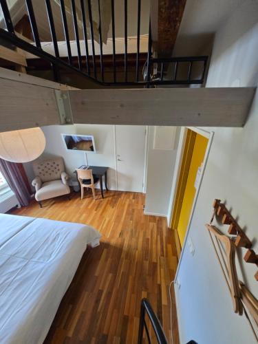 a loft bedroom with a bed and a desk at Norrqvarn Hotel & Resort by Vänerport in Lyrestad
