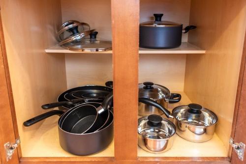 a cabinet with pots and pans in it at Louisville Louvre in Louisville