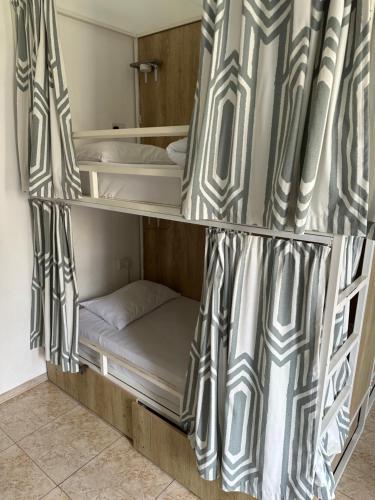 Cama o camas de una habitación en Follow the Sun Boutique Hostel - Pool, Breakfast & Sea Views
