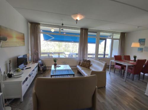a living room with a couch and a table at VUURTOREN Bed by the Sea in Westkapelle