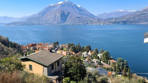 a small town on a hill with a large body of water at Villa gli Ulivi - Bariloche Lake & Mountain View in Perledo