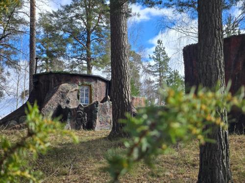 an old stone house in the middle of trees at Norrqvarn Hotel & Resort by Vänerport in Lyrestad