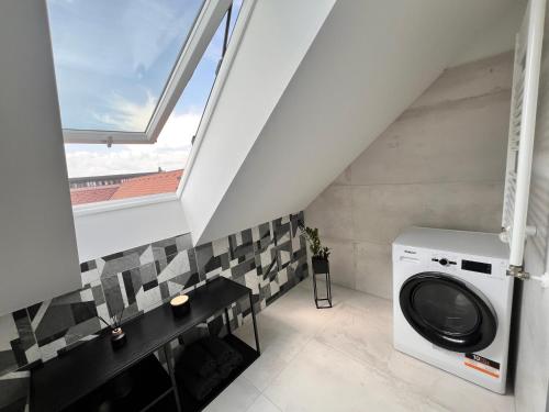 a washing machine in a laundry room with a window at Stay in Trnava in Trnava