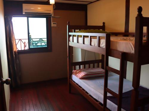 two bunk beds in a room with a window at Tioman Beruntun Hideaway in Tioman Island