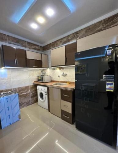 a kitchen with a sink and a dishwasher at Hyat Apartments in Alexandria