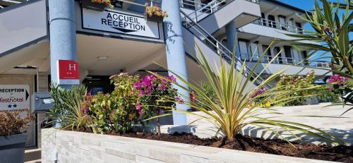 a hospital with flowers in front of a building at Fasthotel Roissy - Saint-Witz in Saint-Witz