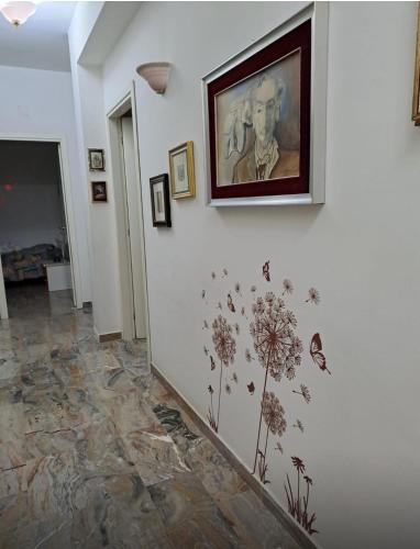 a hallway with a painting of a man on a wall at Tiz Home in Canicattì