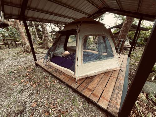 a tent that is sitting on a wooden deck at Jimmy Explorer Campsite and Dive Center in Lanyu