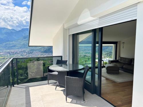 a living room with a table and chairs on a balcony at Garda Suite 50 in Arco
