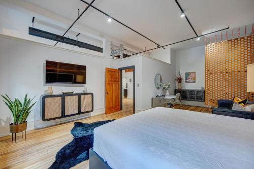 a bedroom with a large bed and a living room at Luxe 220, Unit 2 - Front Street Suite in Wilmington