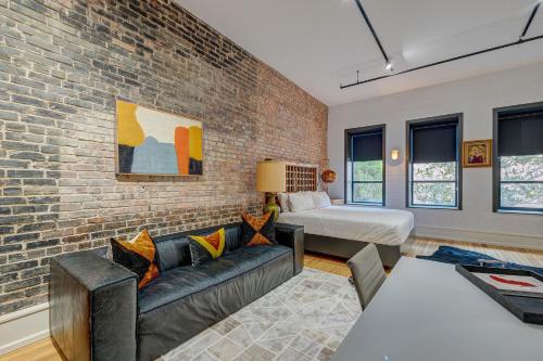 a living room with a brick wall at Luxe 220, Unit 2 - Front Street Suite in Wilmington
