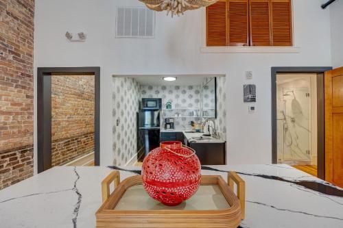 a red vase sitting on a table in a kitchen at Luxe 220, Unit 2 - Front Street Suite in Wilmington