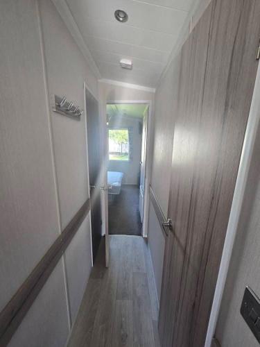 a hallway with a door leading to a bathroom at Haven Burnham on sea 16 Elm Grove in Burnham on Sea
