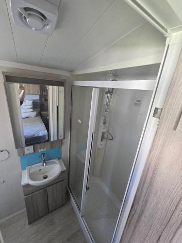 a small bathroom with a shower and a sink at Haven Burnham on sea 16 Elm Grove in Burnham on Sea
