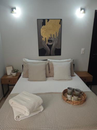 a bedroom with a bed with a tray on it at Mary's Cozy apartment in Alexandroupoli