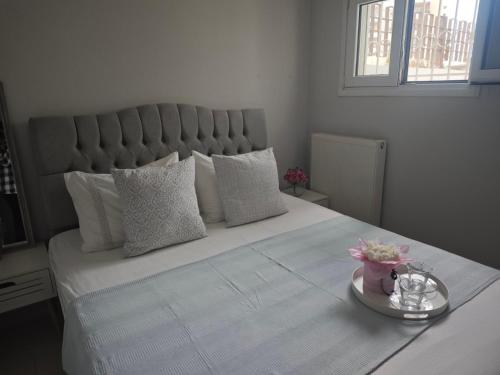 a bedroom with a large bed with white sheets and pillows at Mary's Cozy apartment in Alexandroupoli