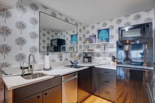 a kitchen with a sink and a refrigerator at Luxe 220, Unit 5 - Adjacent City View Suites in Wilmington