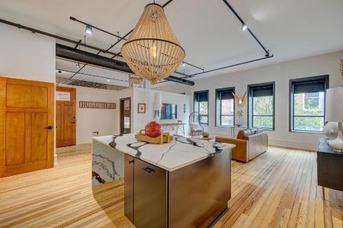 an open kitchen and living room with a chandelier at Luxe 220, Unit 5 - Adjacent City View Suites in Wilmington