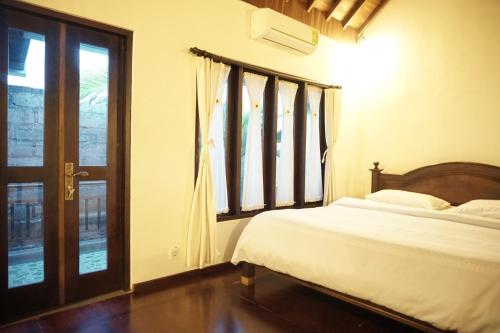 Tempat tidur dalam kamar di Praschita Bali