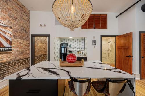 a kitchen with a large table and a chandelier at Luxe 220, Unit 7 - Entire Penthouse Property - sleeps 20 in Wilmington