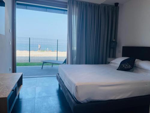 a hotel room with a bed and a large window at Bardolino Luxury in Bardolino