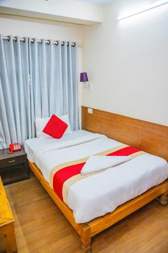 a bedroom with two beds with a red pillow at Great Doors Thamel in Kathmandu