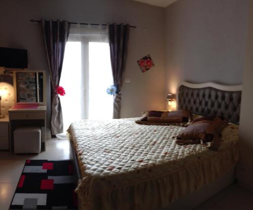 a bedroom with a large bed and a window at Guest house Stone Dream Ohrid lake view in Udënisht