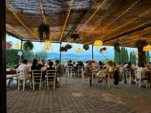 a group of people sitting at tables in a restaurant at Agriturismo Sottotono in Carmignano