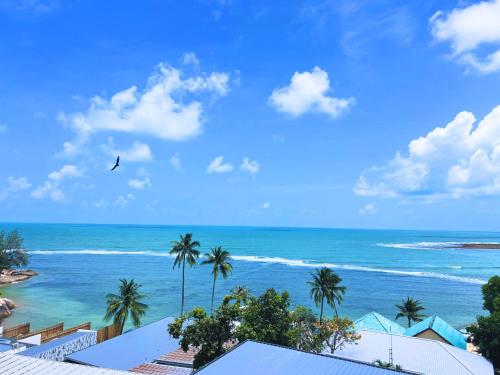 a view of the ocean from a resort at Three Trees Samui Resort - Sarocha Villa in Lamai