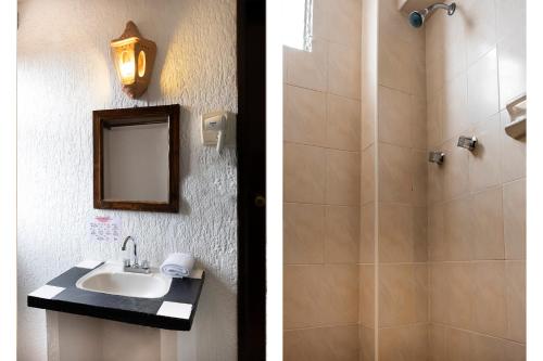 a bathroom with a shower and a sink and a mirror at Capital O Hotel Central, Xalapa in Xalapa