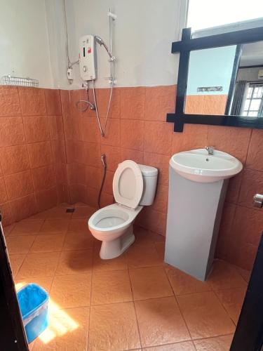 a bathroom with a toilet and a sink at Local Guesthouse in Vang Vieng