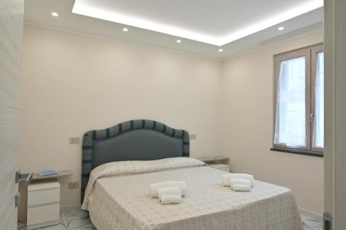 a bedroom with a bed with two pillows on it at Fior di Zagara Suites in SantʼAntonio Abate