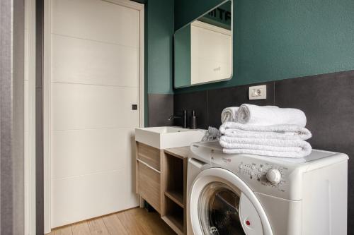 a bathroom with a washing machine and a sink at Stay&Fly Milano - Linate Airport in Segrate