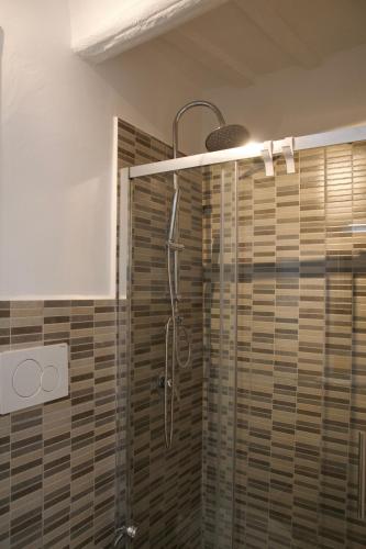 a shower with a glass door in a bathroom at La Casa di Alice in Perugia