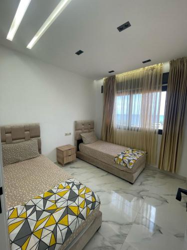 a living room with two beds and a couch at Oumaira Residence Azla-Tetouan in Azla