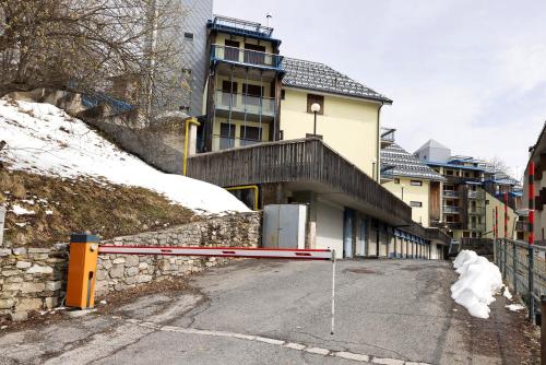 a street in front of a building with snow at Plain Soleil ski home in Prato Nevoso