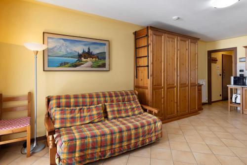 a living room with a couch and a painting on the wall at Plain Soleil ski home in Prato Nevoso