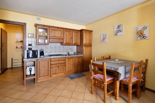 a kitchen with a table and a stove top oven at Plain Soleil ski home in Prato Nevoso