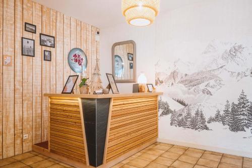 a room with a desk with a mirror on a wall at Alti'Pic Hôtel in Le Mont-Dore