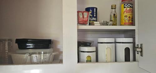a kitchen cabinet with food items inside of it at Las Julies's Apartment in Arenales