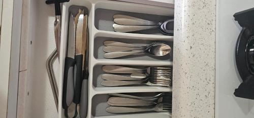 a drawer full of utensils in a cabinet at Las Julies's Apartment in Arenales