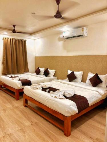 two beds sitting in a room with at Baga Beach Way in Baga