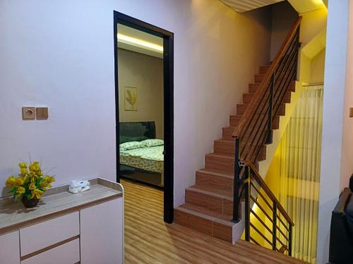 a hallway with a stairway leading to a bedroom at Papi Villa O3 in Tlekung