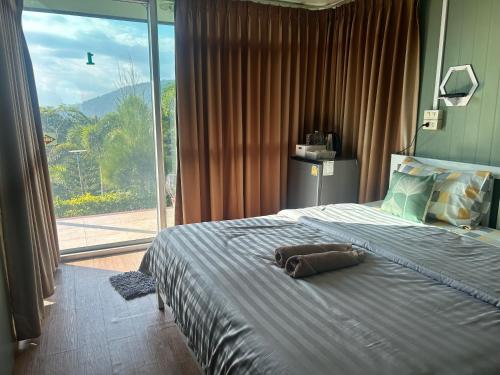 a bedroom with a bed with a stuffed animal on it at FreshBloom View เขาค้อ Green House in Khao Kho